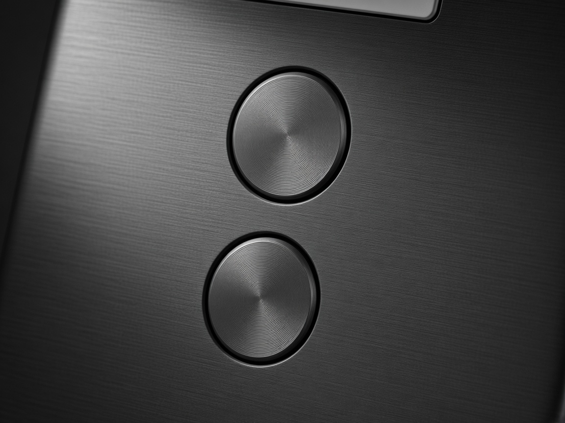 Close-up of the two circular metal buttons on the CREATO wallet